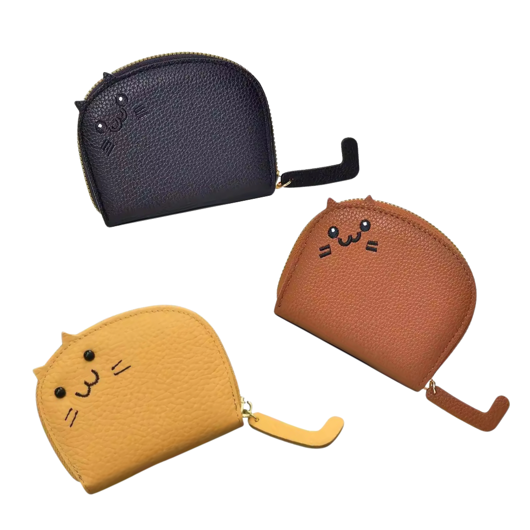 Brown, yellow, and black credit card wallets shaped like a cat with a sweet face and little ears. The zipper closure is the cat’s tail.