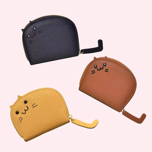 Three cat-shaped coin purses in black, brown, and yellow on a white background