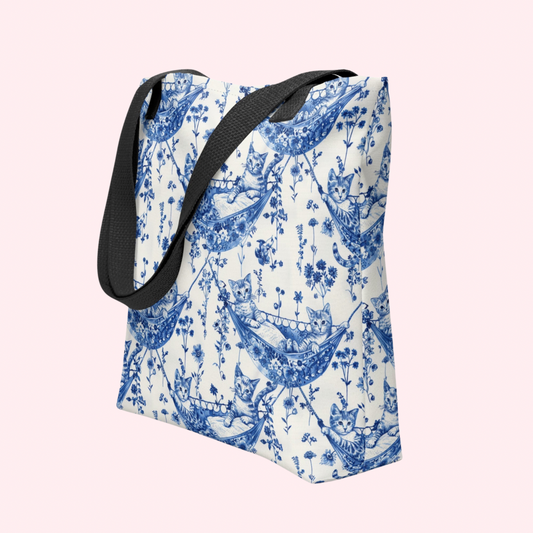 Blue chinoserie toile pattern of kittens in hammocks on a white background with a black handle