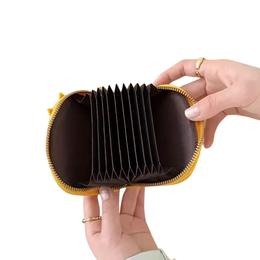 Brown and yellow cardholder held by a hand on a white background