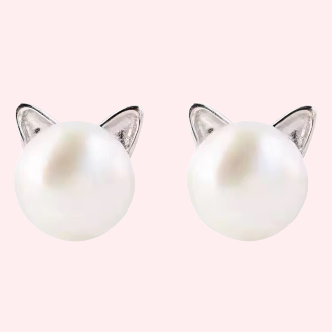 White glass pearl earrings attached to silver cat ear posts