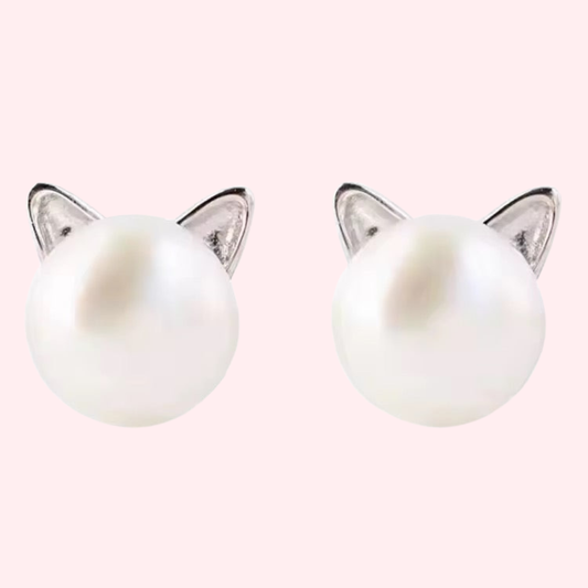 White glass pearl earrings attached to silver cat ear posts