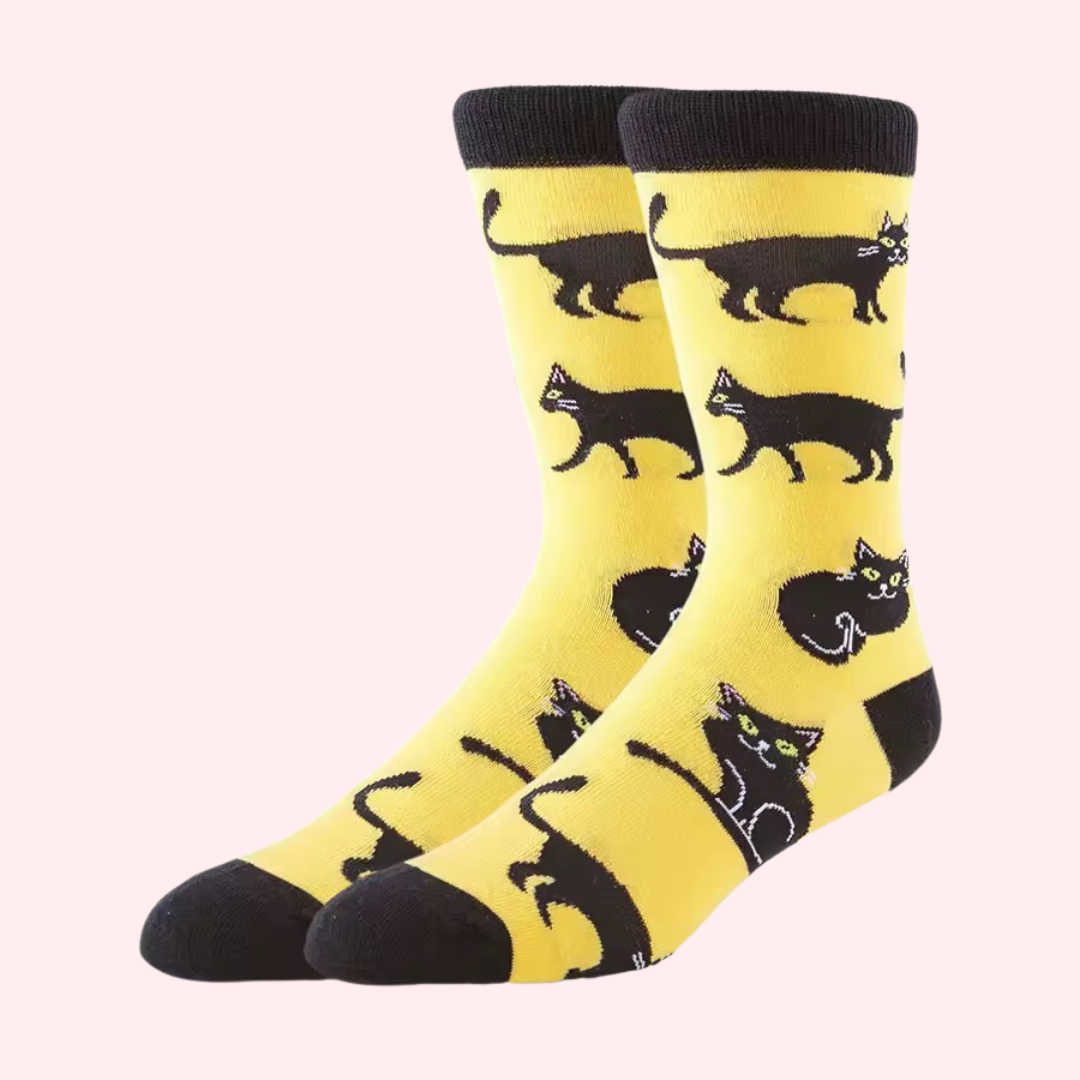 Pair of orange crew socks with black heel and toe with multiple black cats.