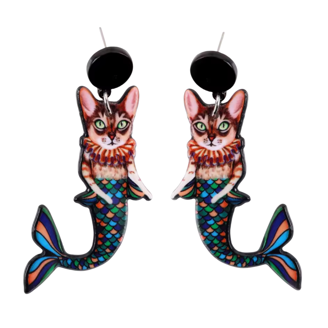 A pair of earrings that are silly cats with mermaid tails 